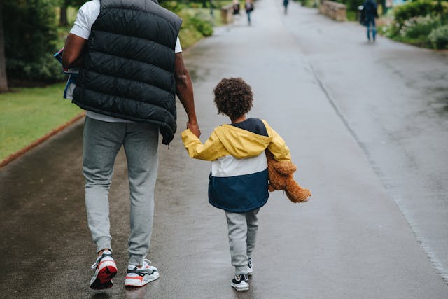 two people walking on road